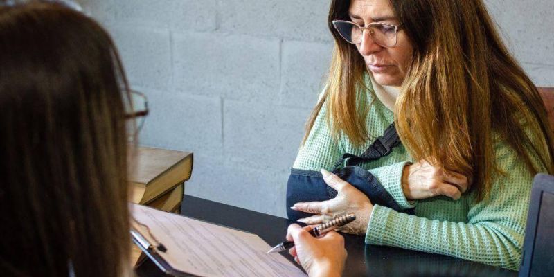 Woman discussing an insurance settlement offer with an attorney