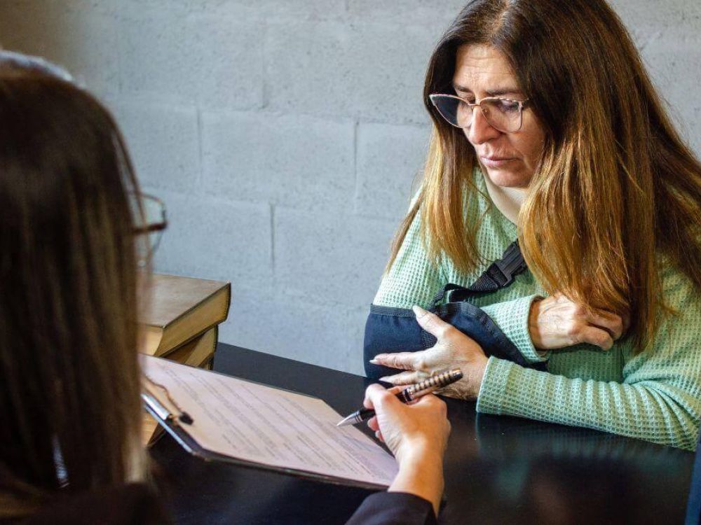Woman discussing an insurance settlement offer with an attorney