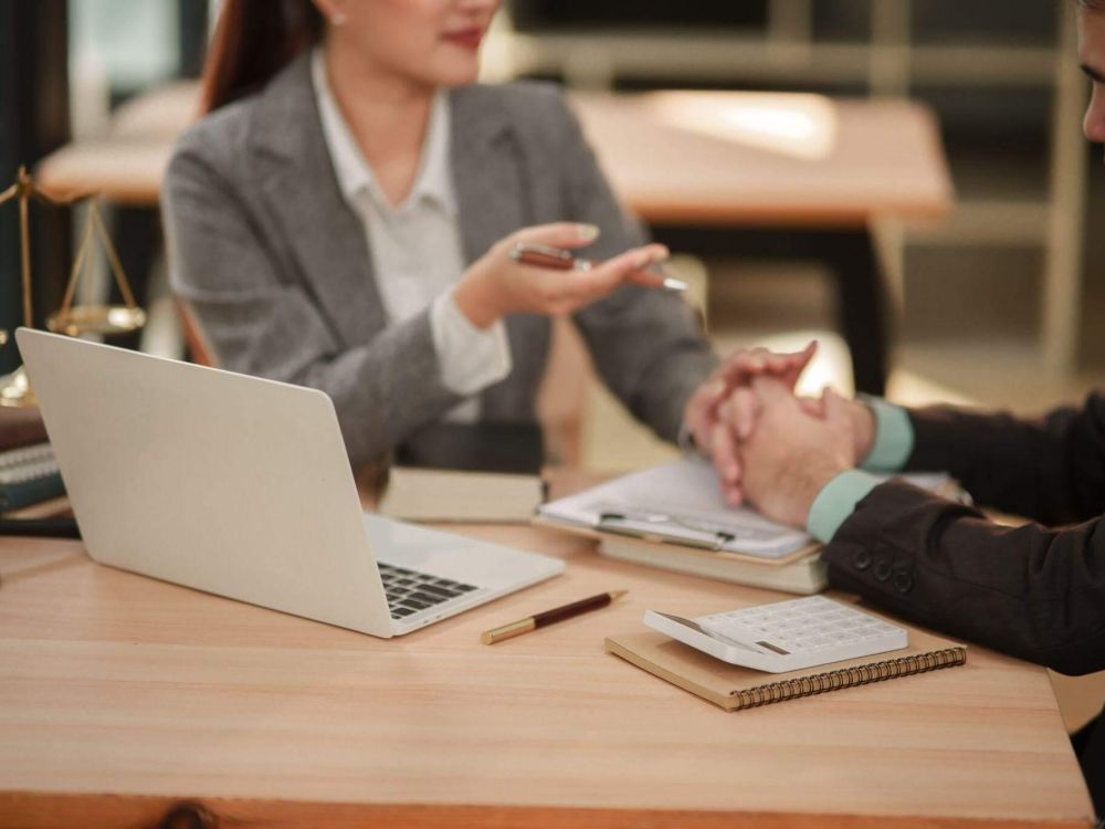 Clients review legal documents on a laptop