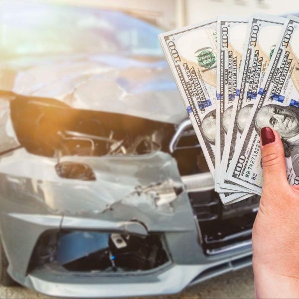 a person holding a bunch of money in front of a car