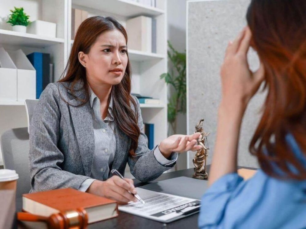 Two women discussing an Uber accident settlement