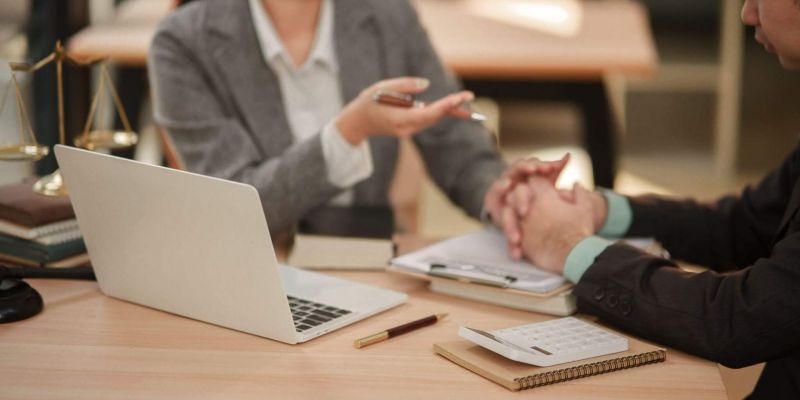 Clients review legal documents on a laptop