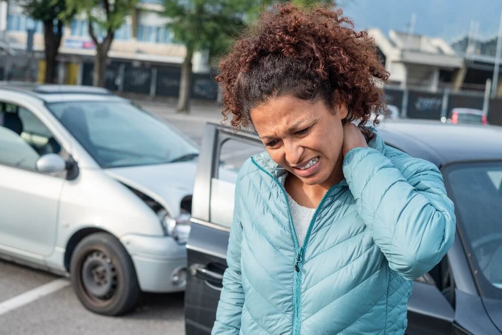 Woman holding her neck in pain after an auto accident