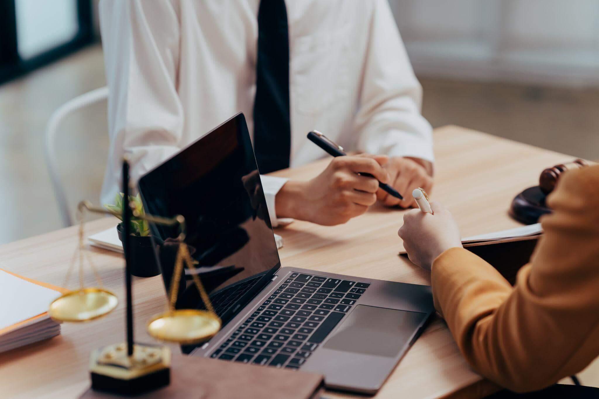 Two people at a table reviewing information on