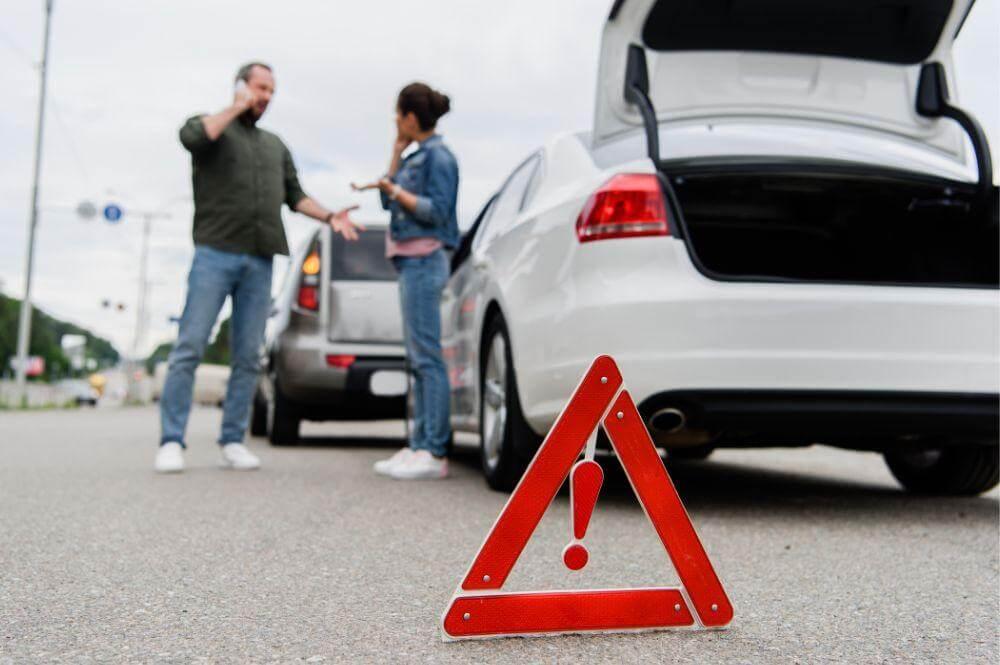 Two people by a car, possibly after an