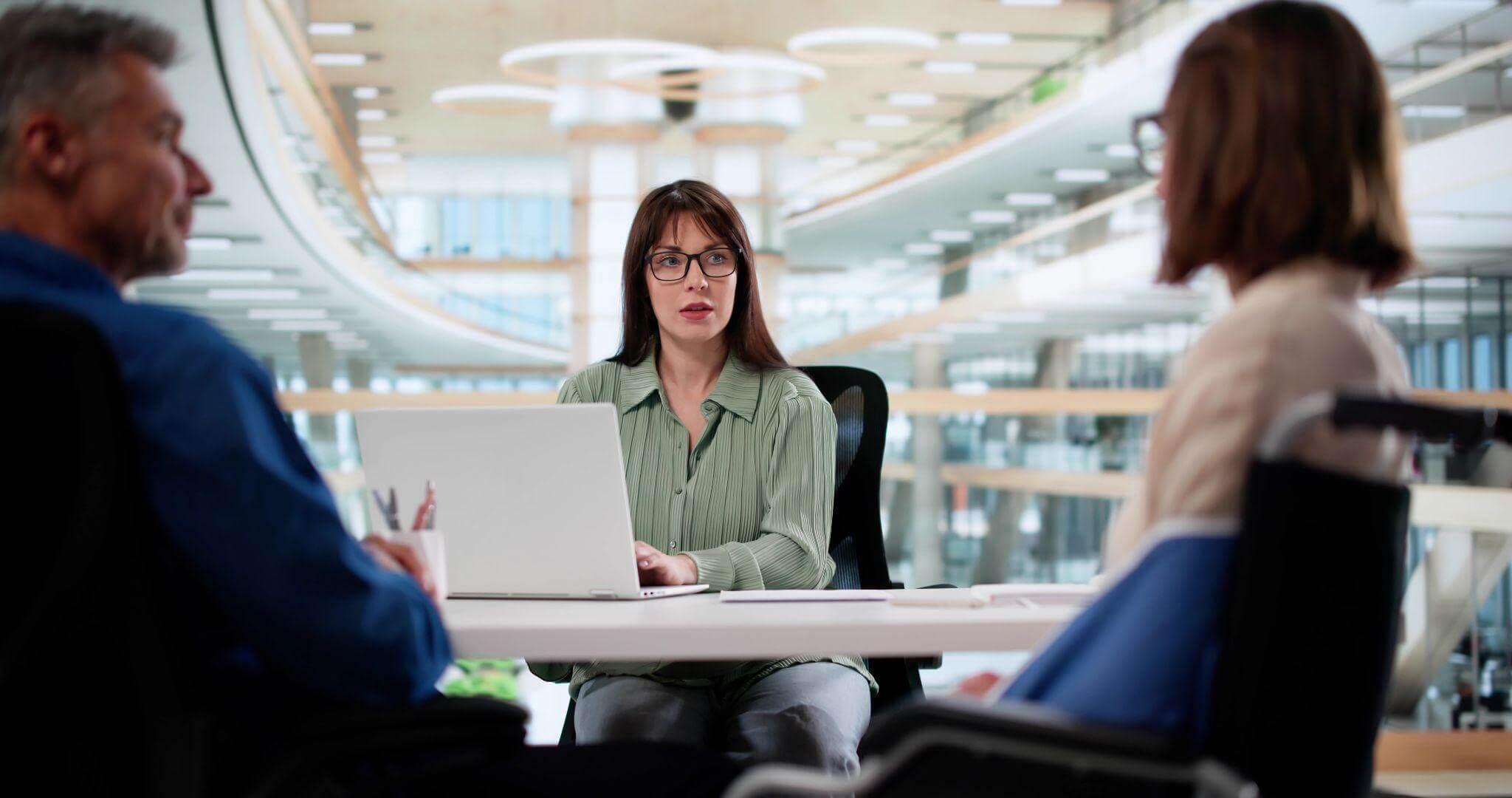 Woman reviewing client information on a laptop