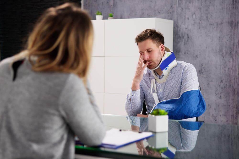 Man at desk contemplating insurance settlement offer