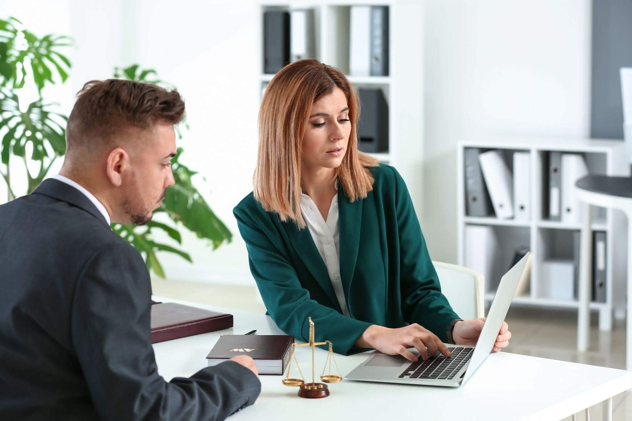 Man and woman reviewing legal documents on