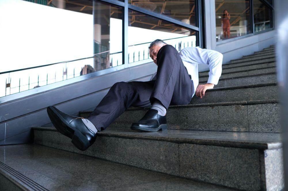 Man in a suit and tie sitting on stairs