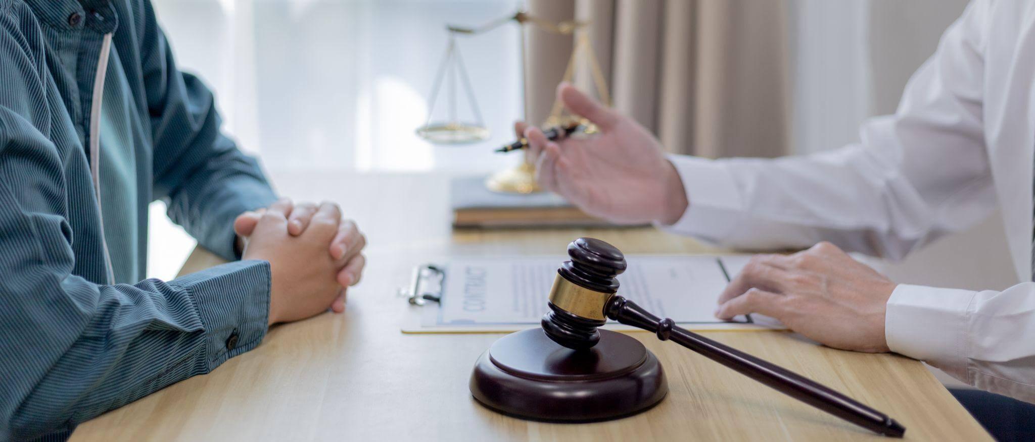Two people at a table with a judge