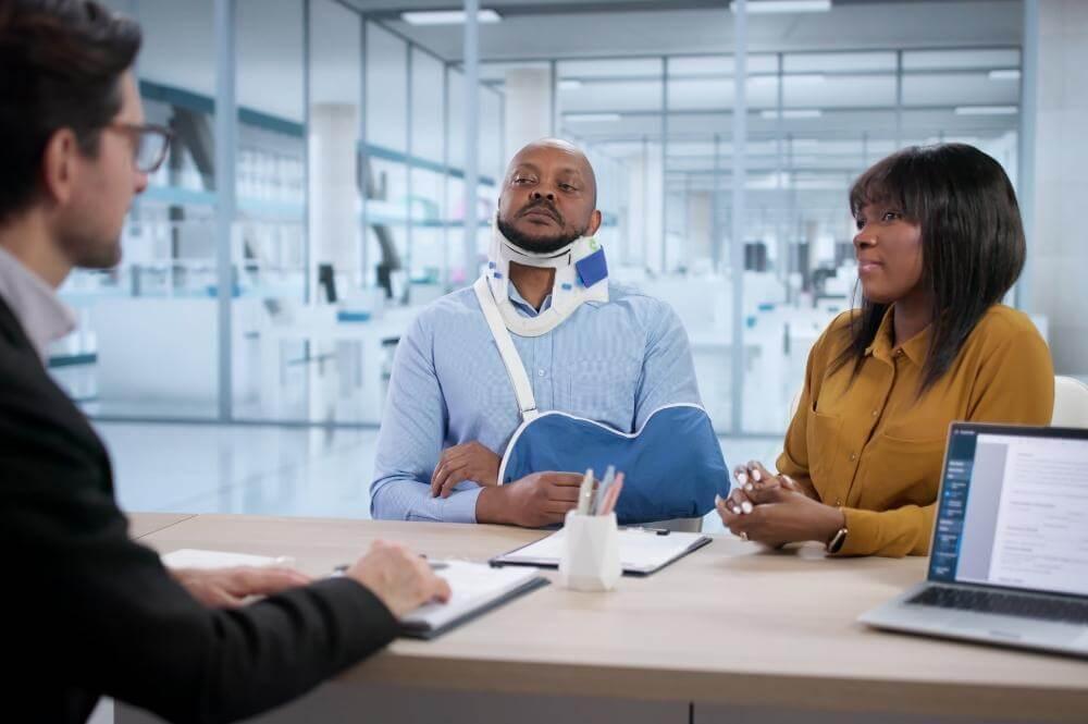 Group of people discussing legal options with a lawyer.